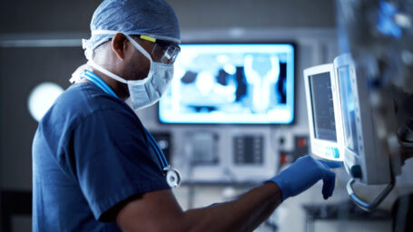 Shot of a surgeon looking at a monitor in an operating room