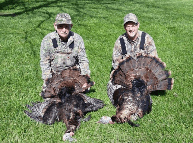 Two hunters with turkeys