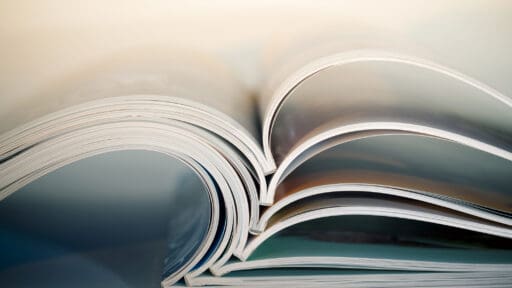 Abstract shot of open magazines stacked on table. Macro shot with shallow depth of field.