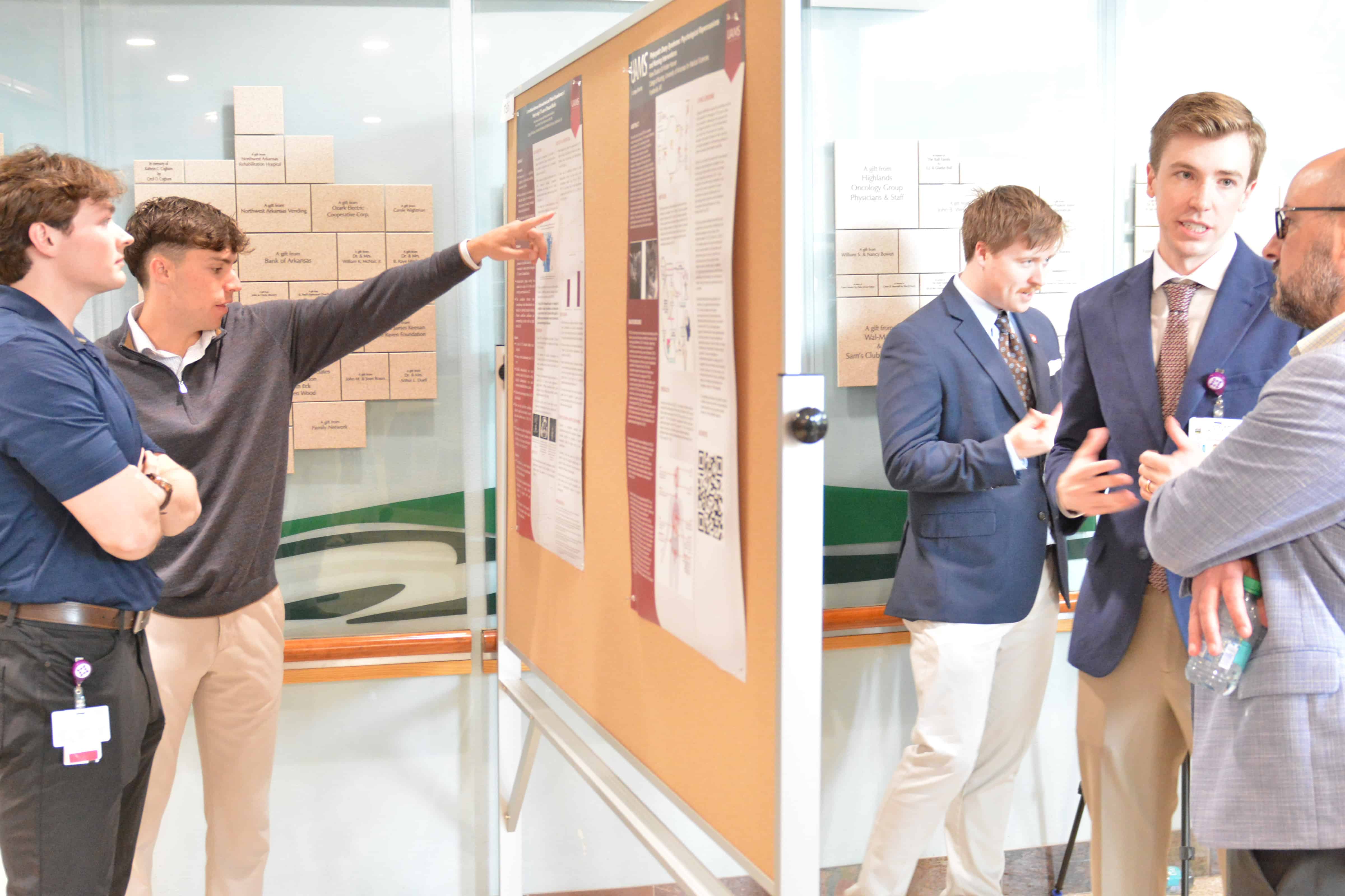 A student pointing to a poster
