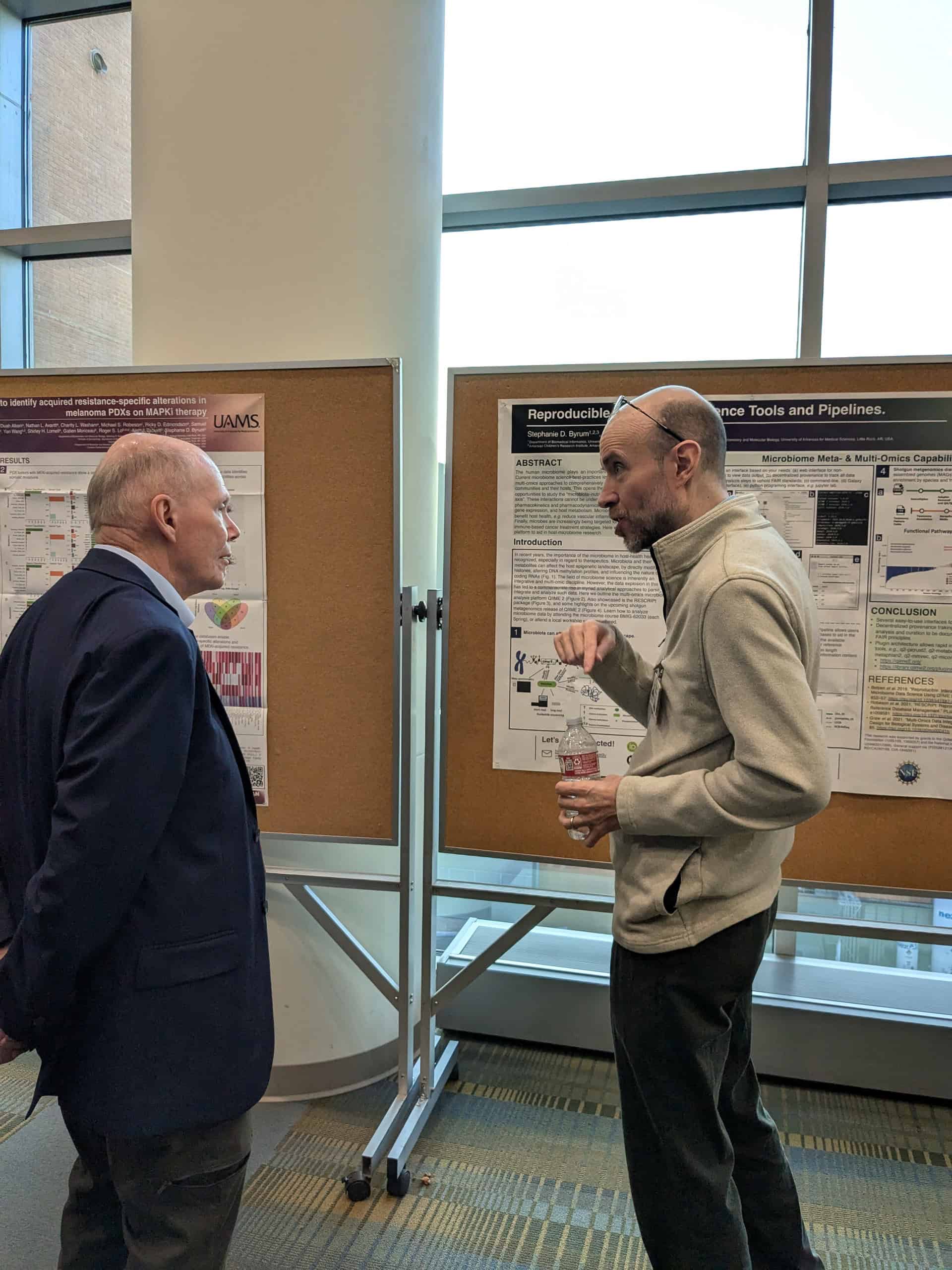 Discussion of a poster between 2 faculty