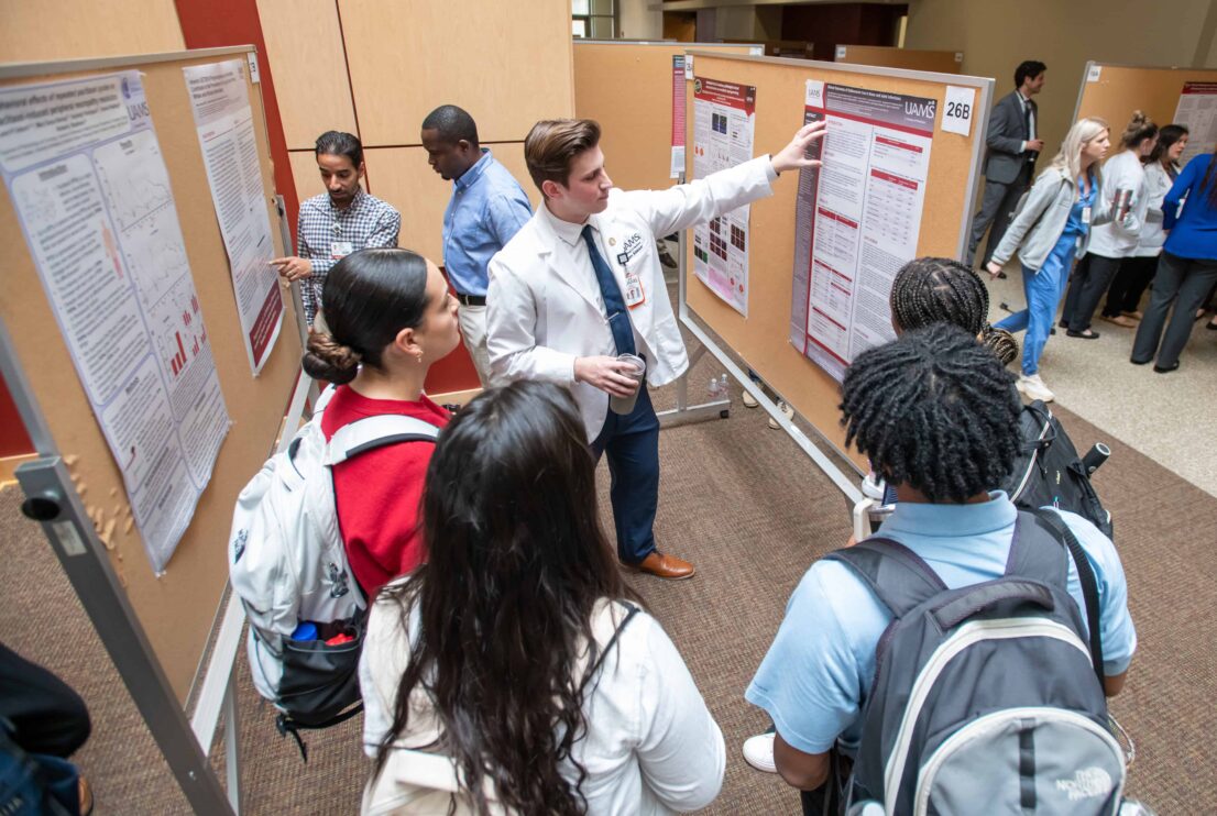 A student presenting a poster