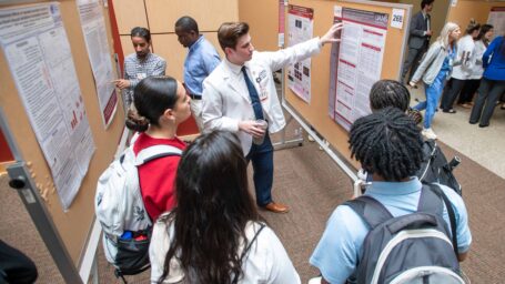 A student presenting a poster